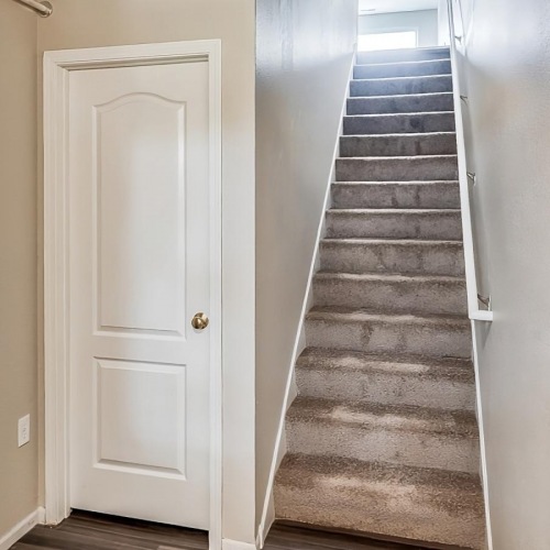 Settle into comfort at Wyngate Townhomes apartment staircase in hall