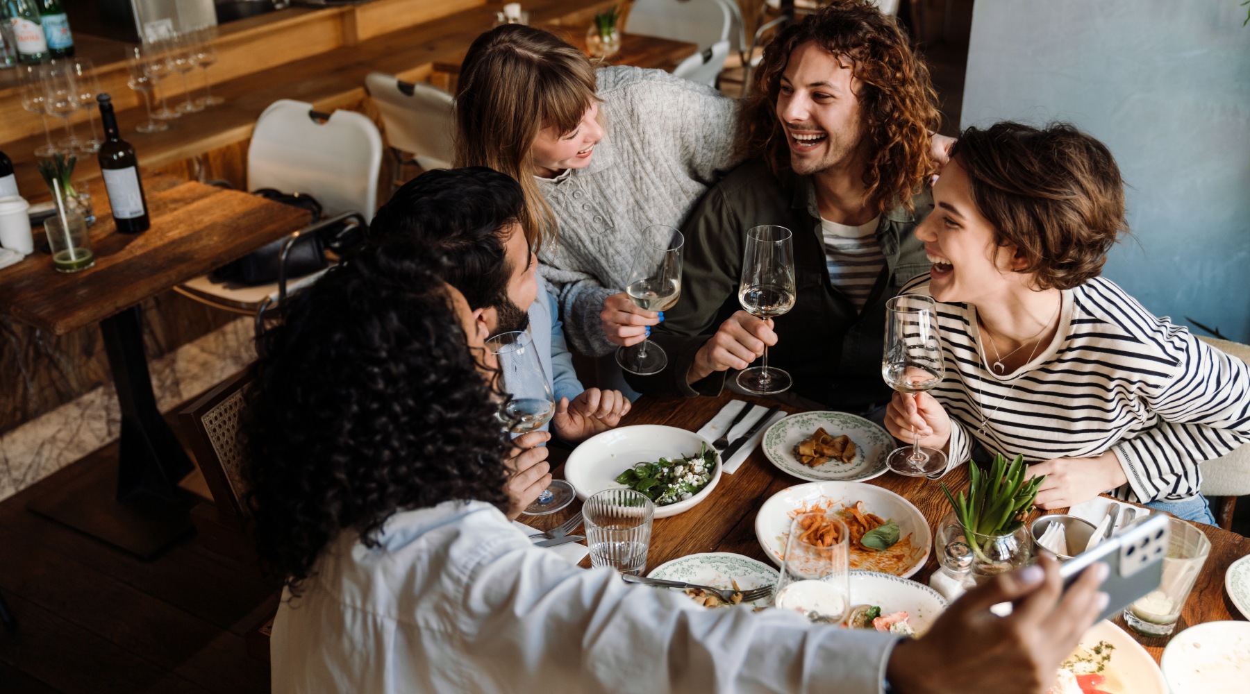 Explore all there is to do in Dakota County Friends laughing around a table with food